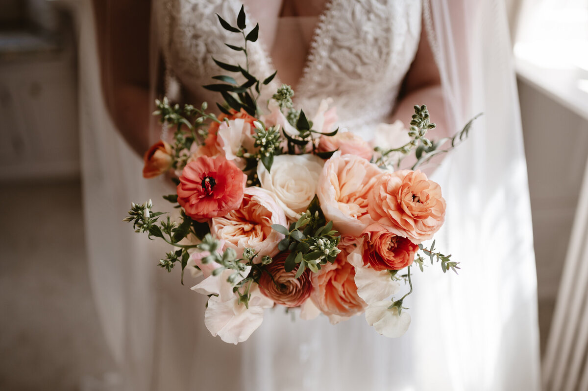 bridal flowers with peach, pink and white buds and greenery