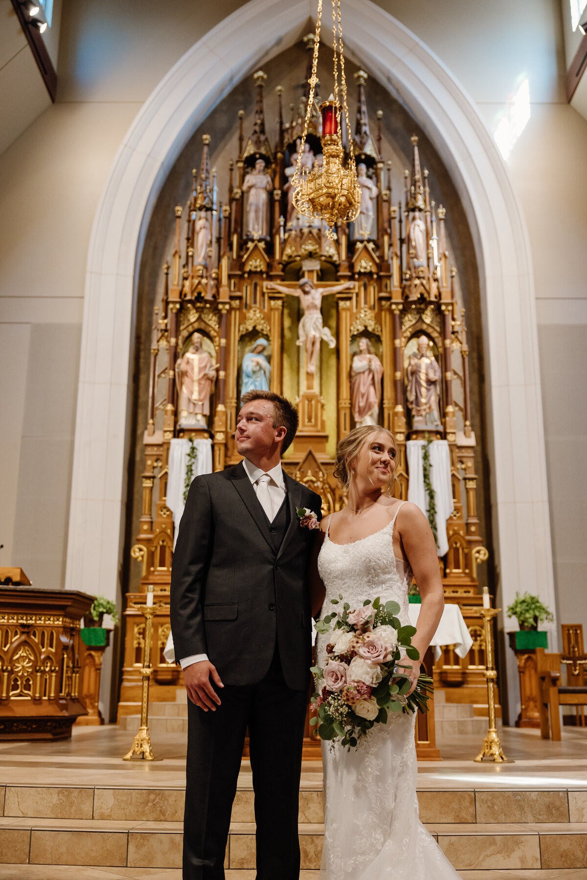 A newlywed standing in front of an altar in a church