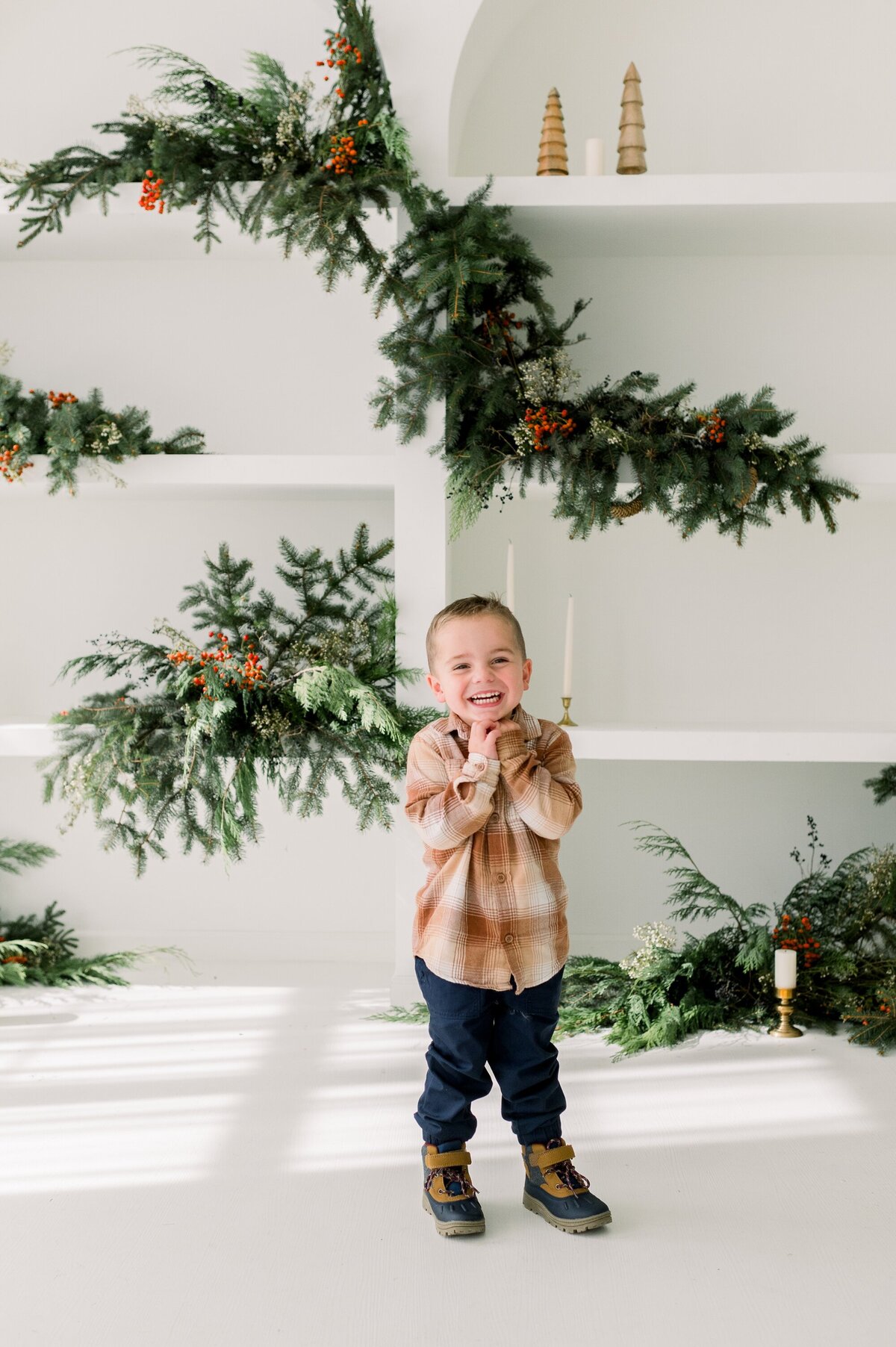 laughing little boy with christmas backdrop