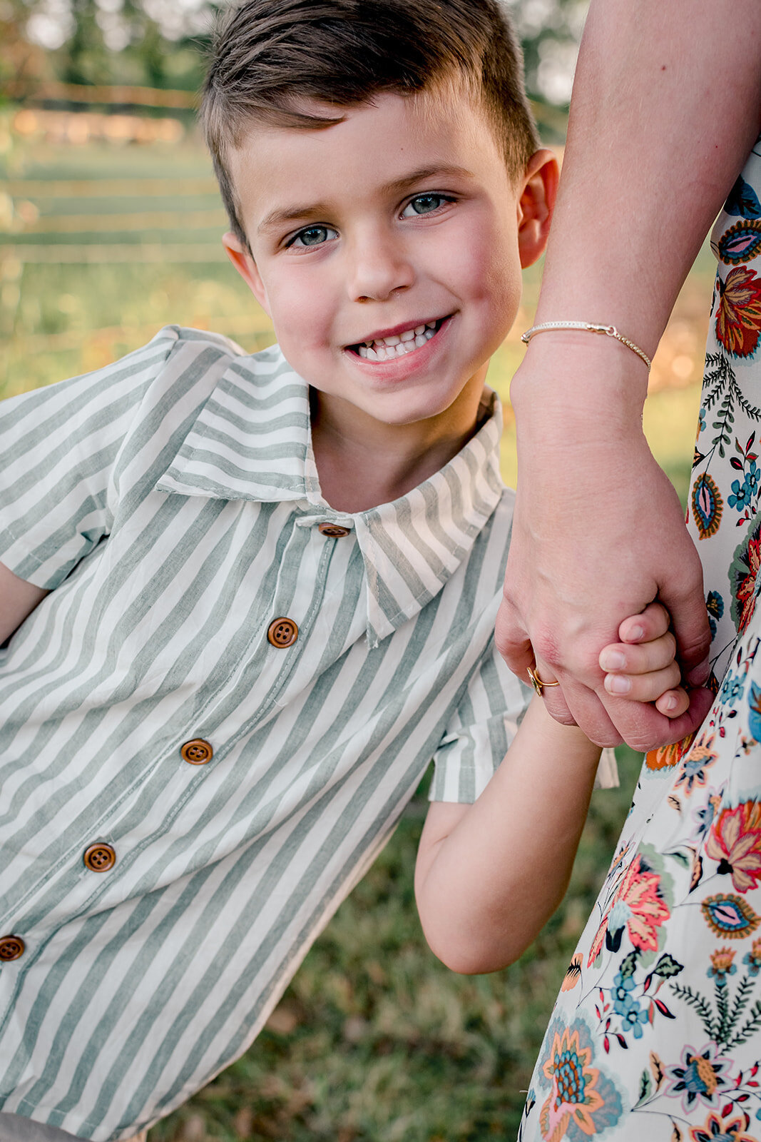 Mother holding her child's hand in natural light during Lafayette photography session.