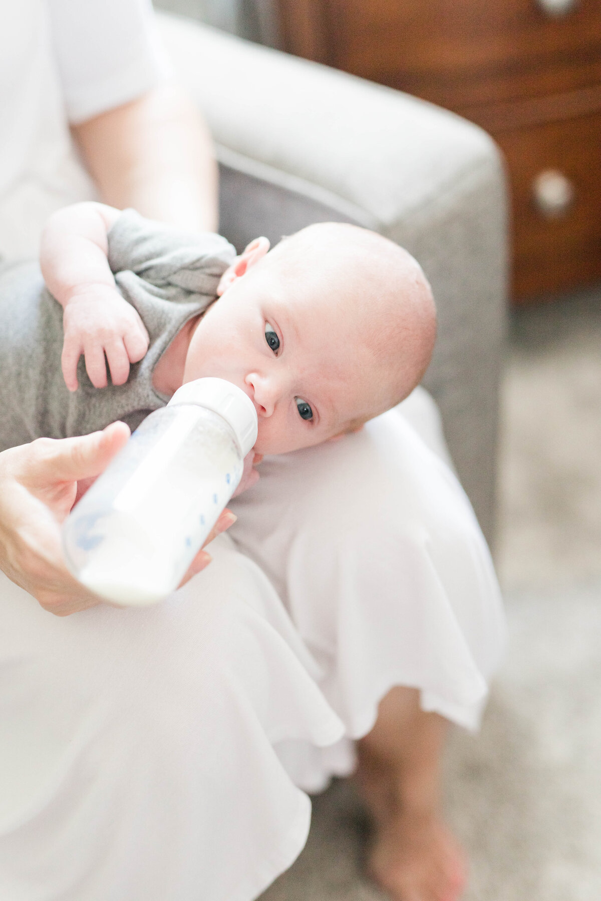 baby being fed bottle during newborn session