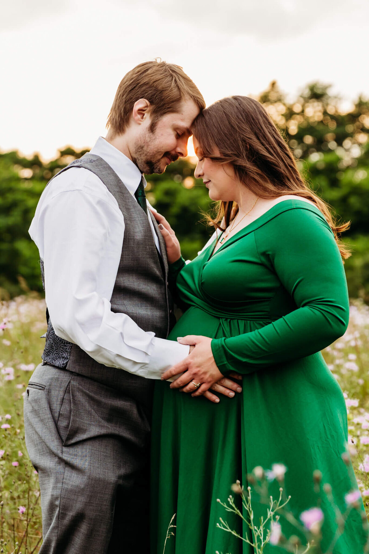 expecting mama and husband embracing their journey to parenthood while holding each other and their baby bump during their Green Bay Maternity photo session
