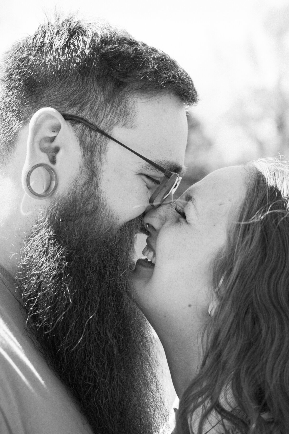 A tattooed couple laughing during their Springfield, MO elopement, captured by Chelsea Stanford.