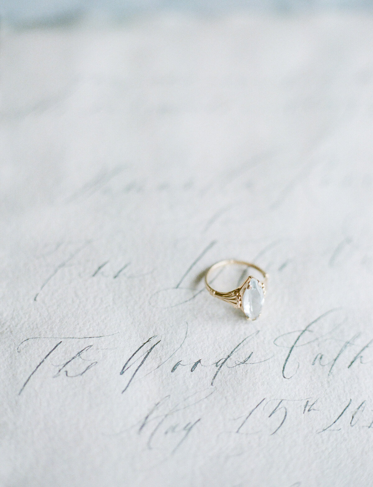 gold engagement ring, marquise cut aquamarine, calligraphy handmade paper simple wedding invitation