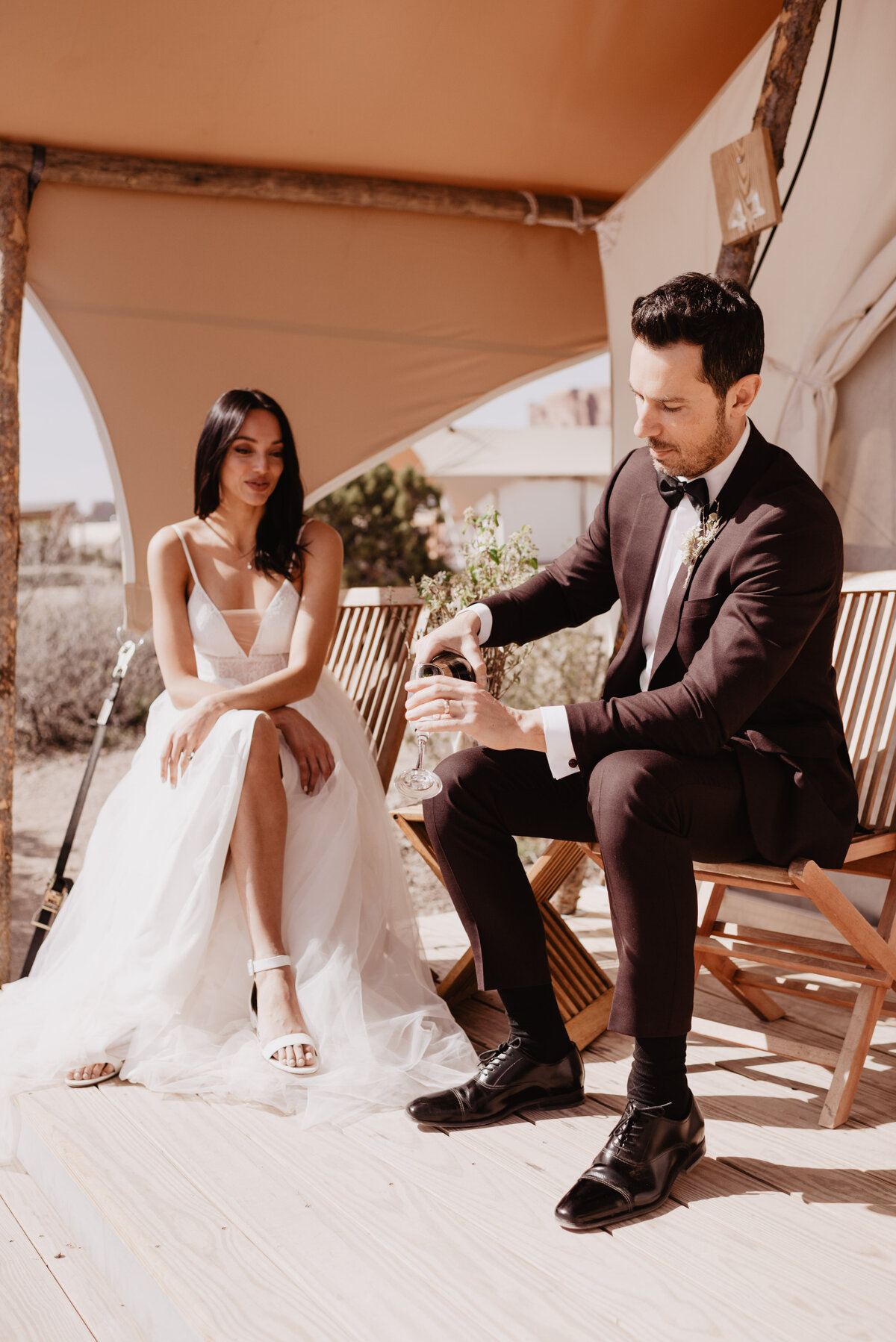 Utah elopement photographer captures groom pouring champagne into glasses