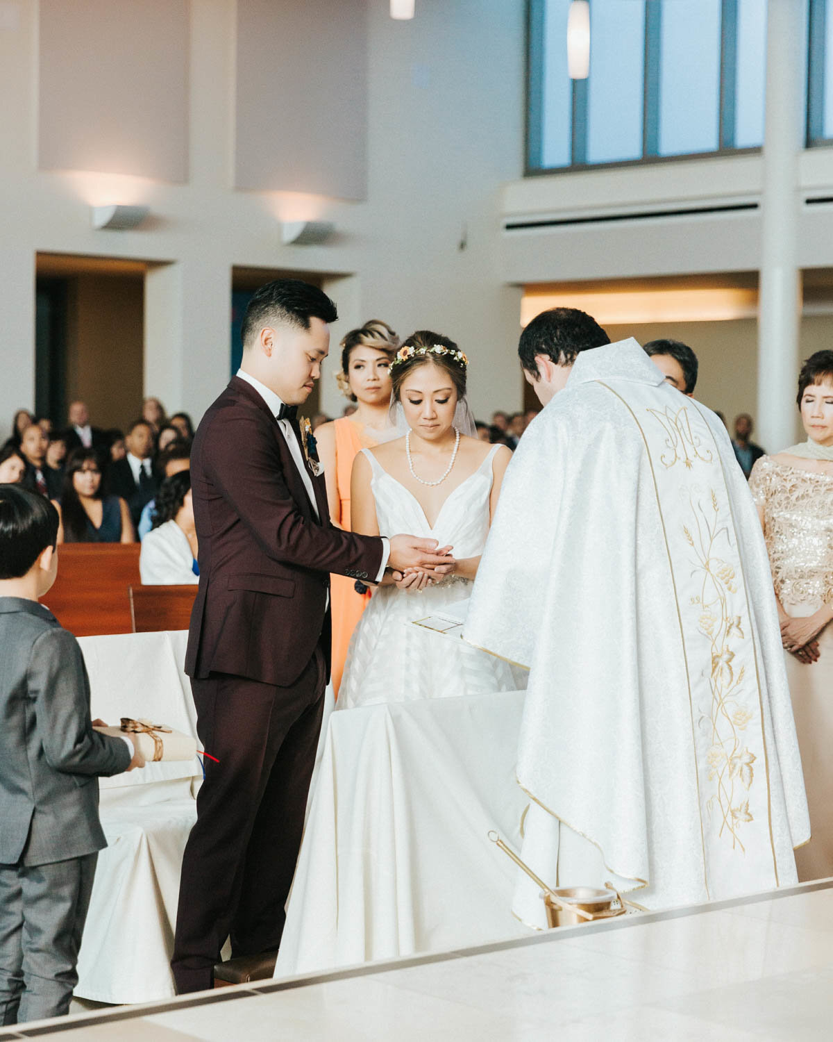 Bride, Groom and Priest stand at the altar holding hands looking down at Kimpton Sawyer Hotel