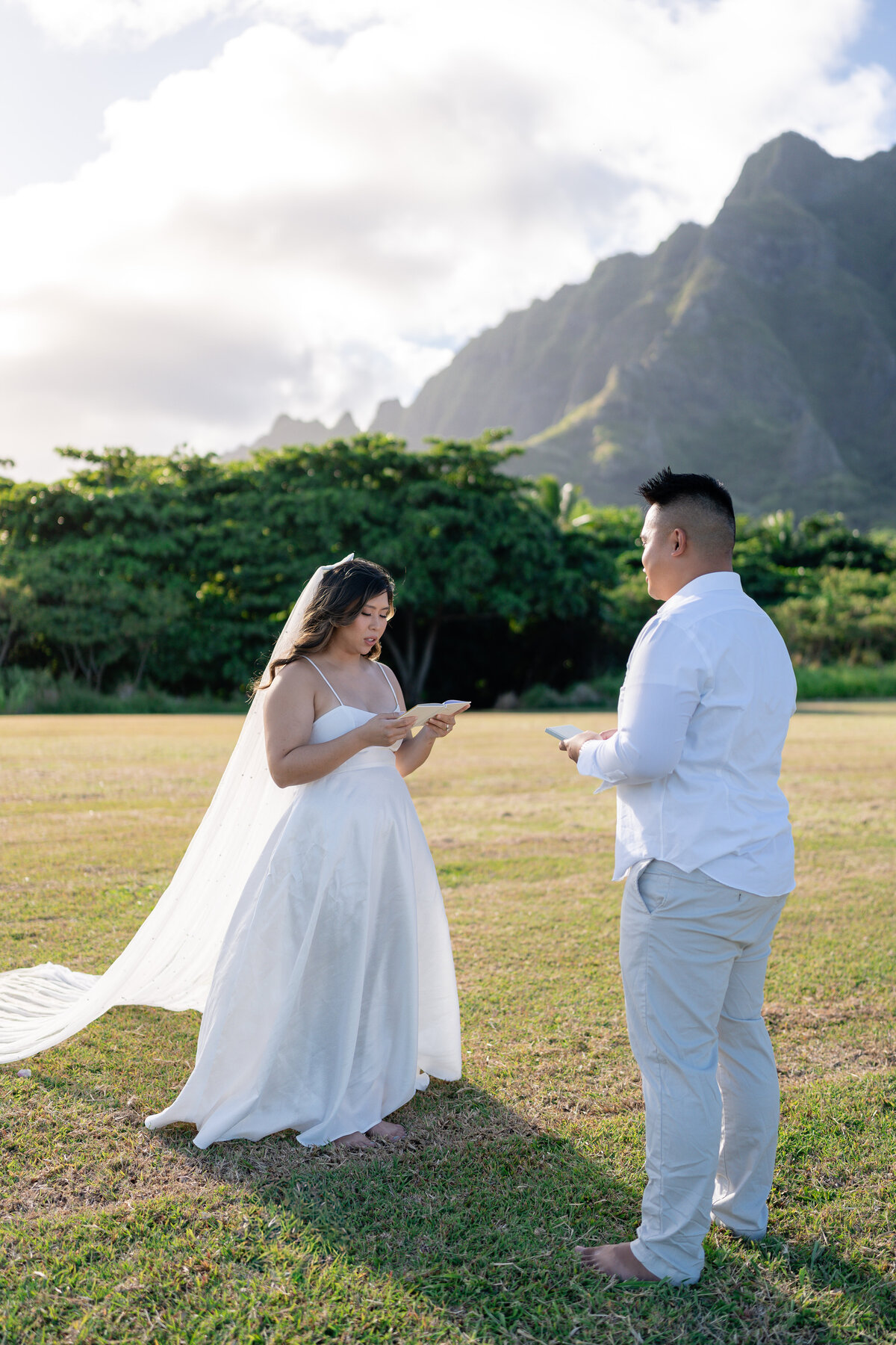 Oahu Hawaii Elopement Asian couple exchanging vows at Kualoa Regional Park during sunset.