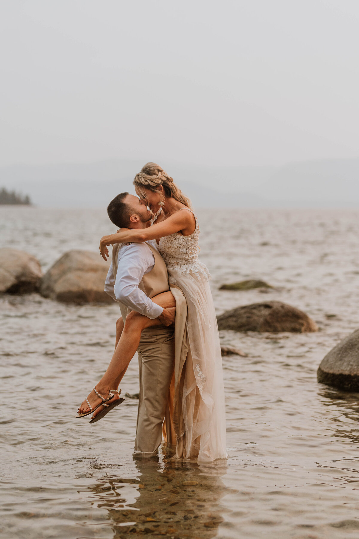 A wedding couple kissing in the Lake Tahoe waters