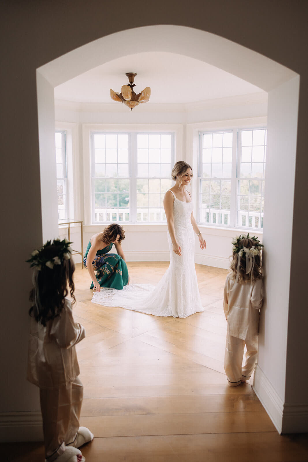 Bride having dress adjusted before finger lakes wedding