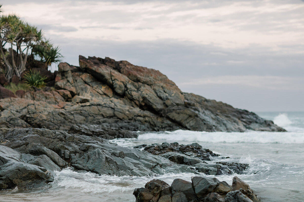 rocky-coastal-shoreline-ocean-waves-cloudy-sky