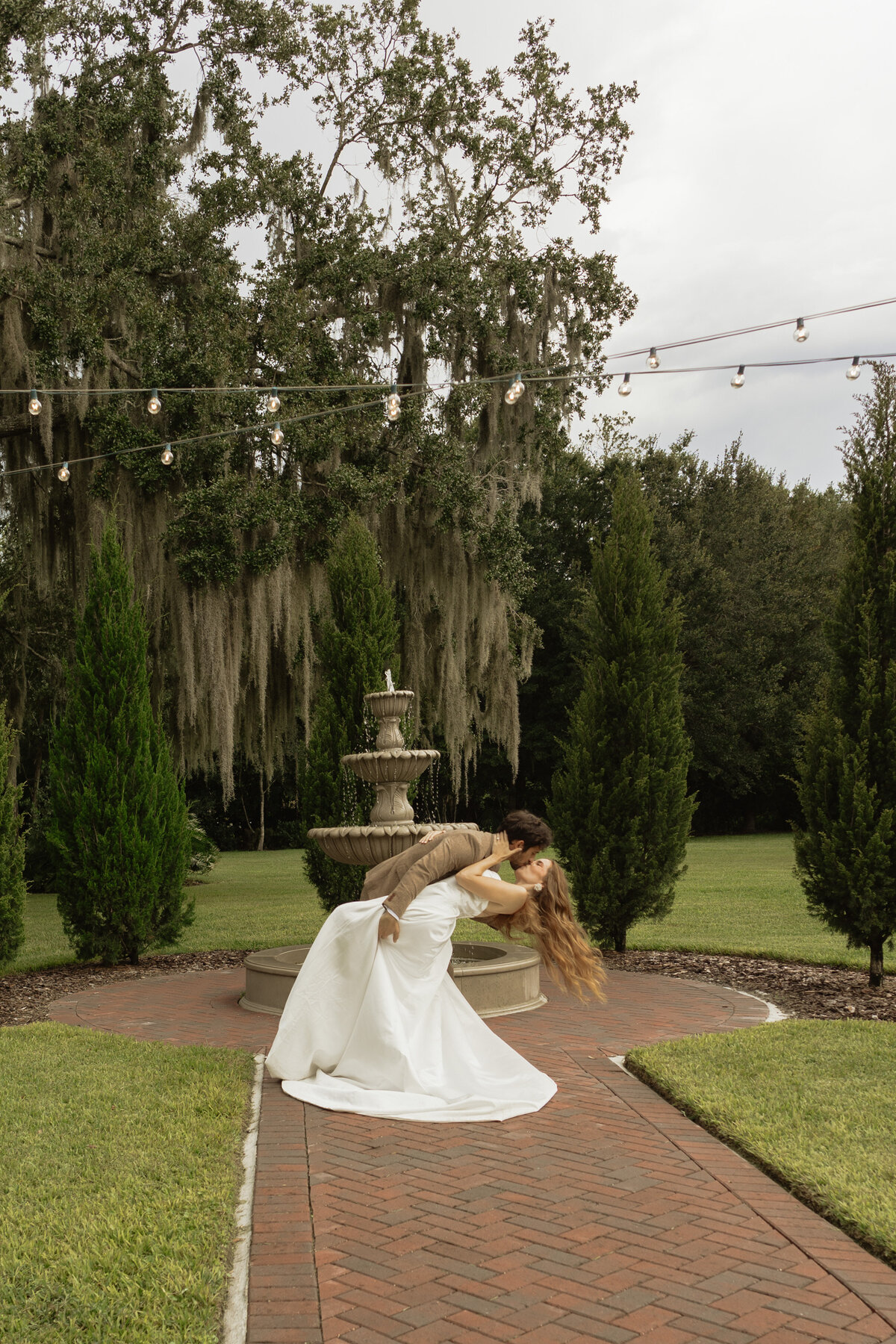Romantic backyard wedding at The Palm Mansion in Umatilla, Florida with lush palm trees and floral arch