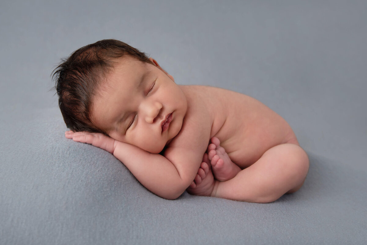 newborn baby boy in taco pose for his Burlington, newborn photography session.