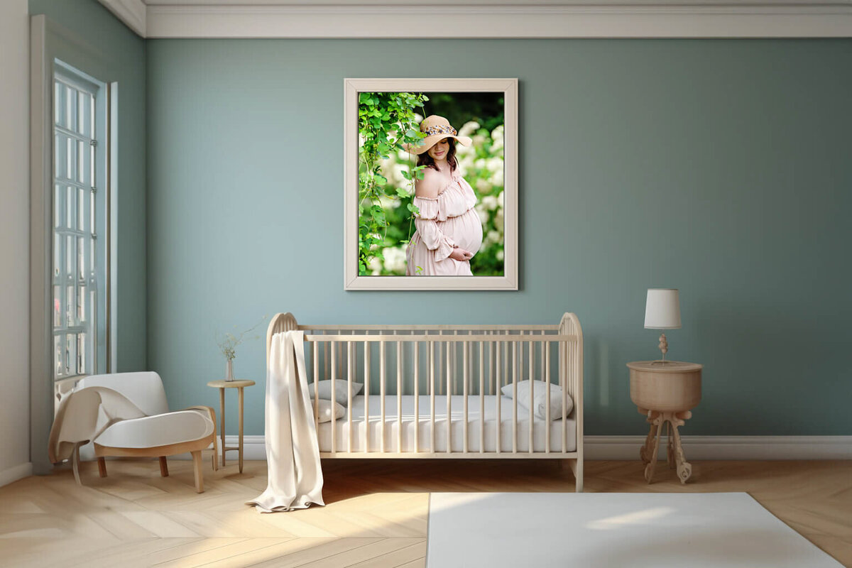 blue nursery room with a framed photo of a pregnant woman at her outdoor Burlington, On maternity photography session
