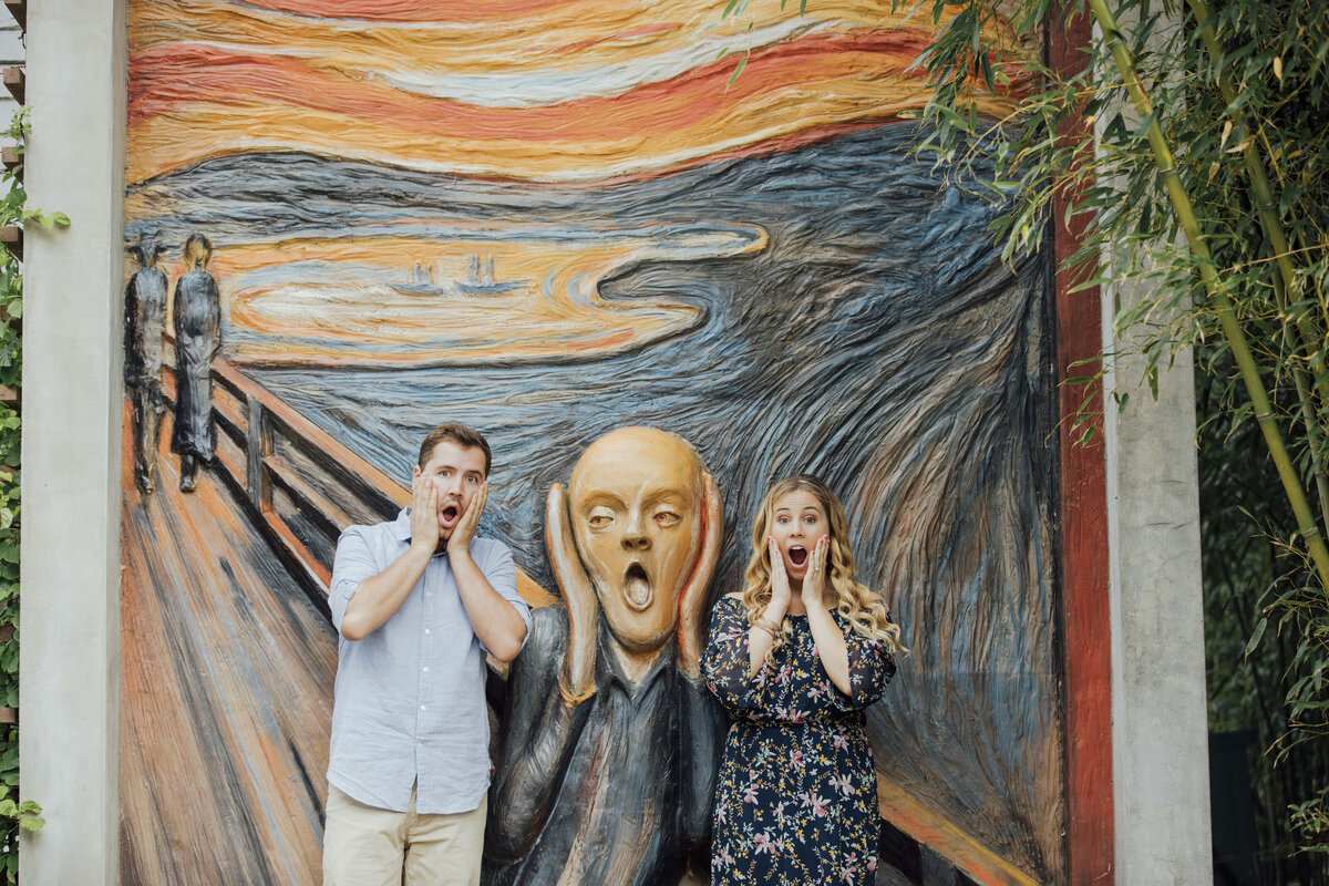 Couple doing a funny pose during engagement photo at Grounds for Sculpture in Hamilton Township New Jersey