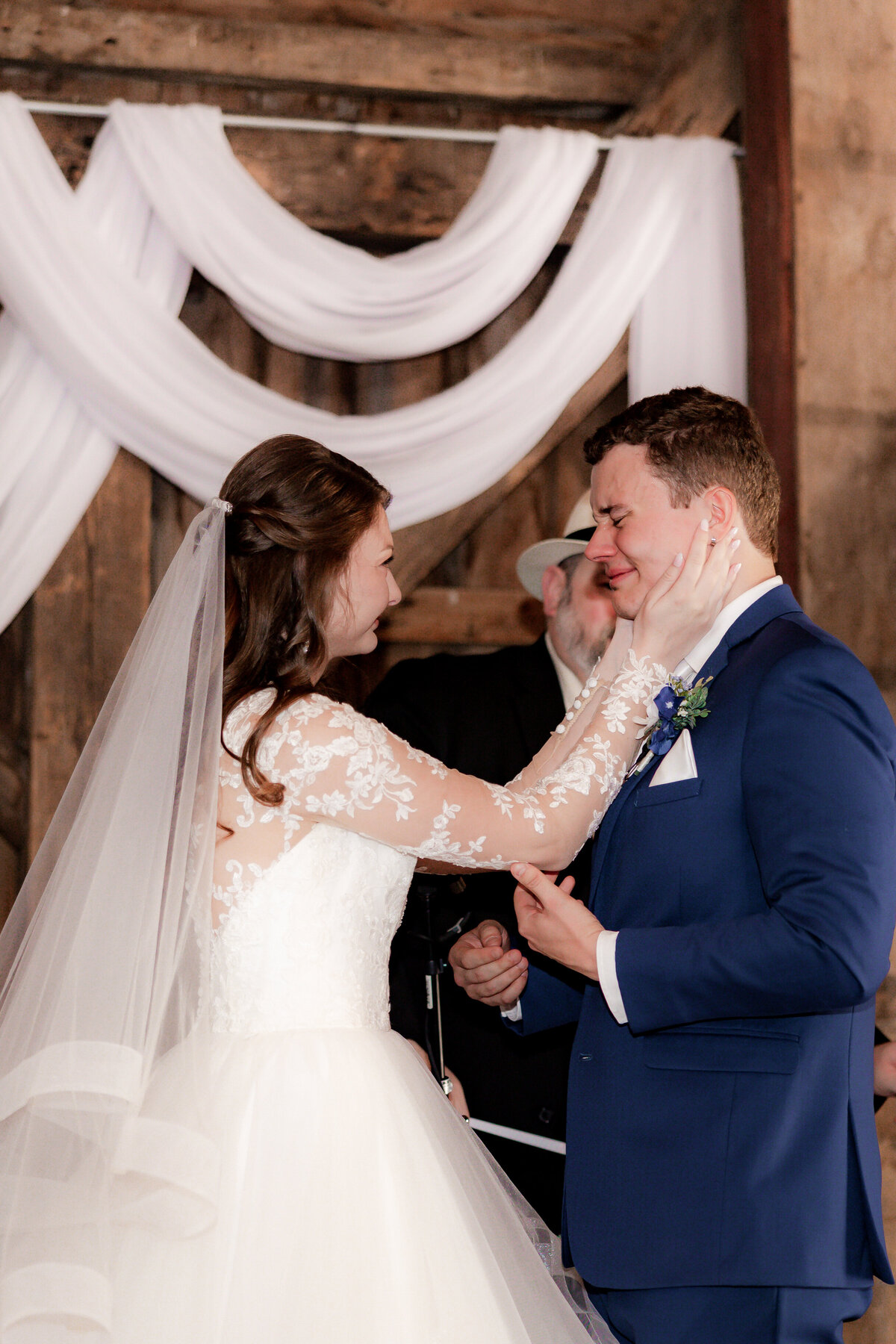 Lori wipes away the tears from her grooms face during their emotional vow exchange.