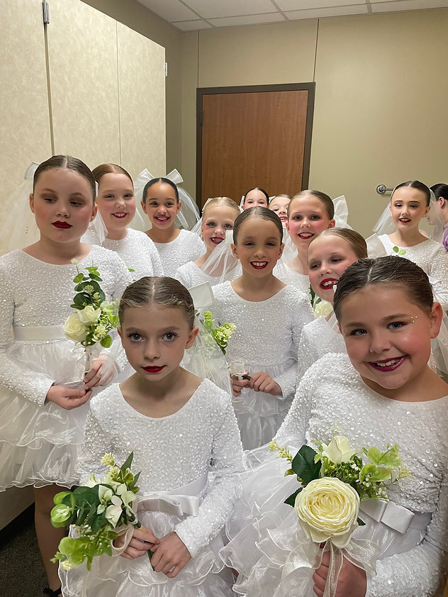 elementary age girls dressed in their bride costumes ready to perform at competition 