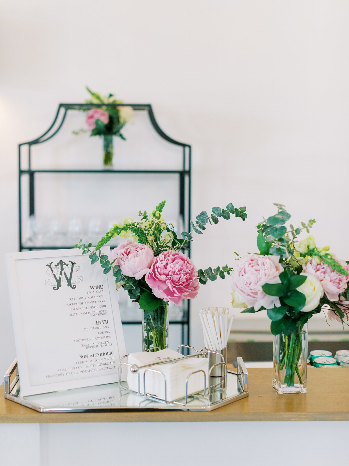 pink flowers on bar with custom black and white menus
