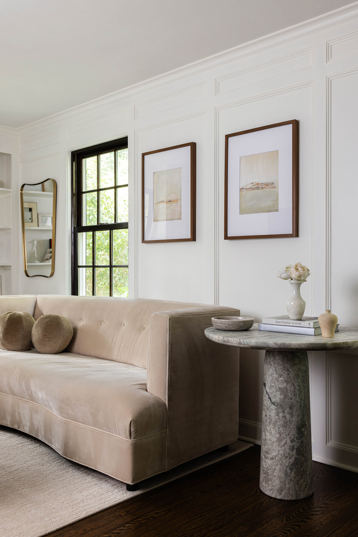 Modern transitional living room design featuring a curved velvet sofa, marble pedestal side table, and neutral art in a Montclair, NJ home by Deni + Dove Interiors — serving clients in Short Hills, Summit, Ridgewood, and Chatham.