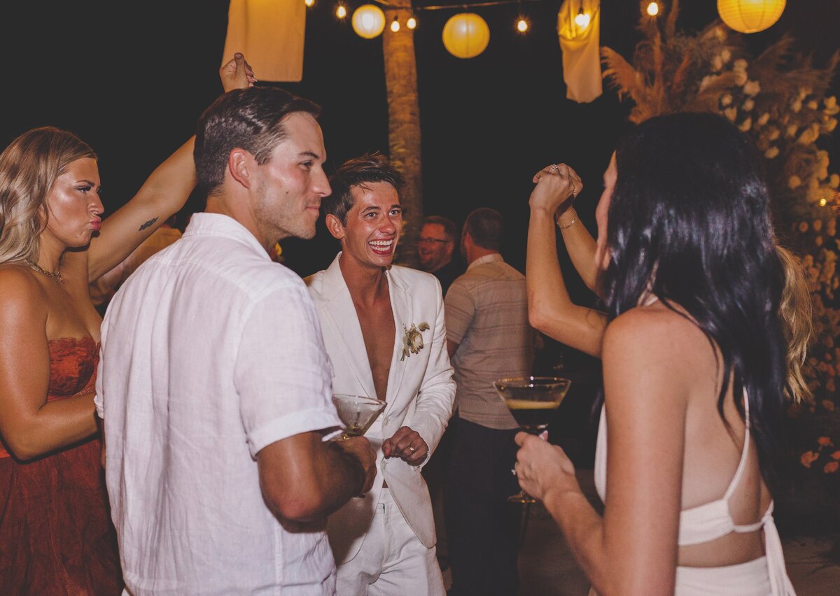 Guests dancing with groom