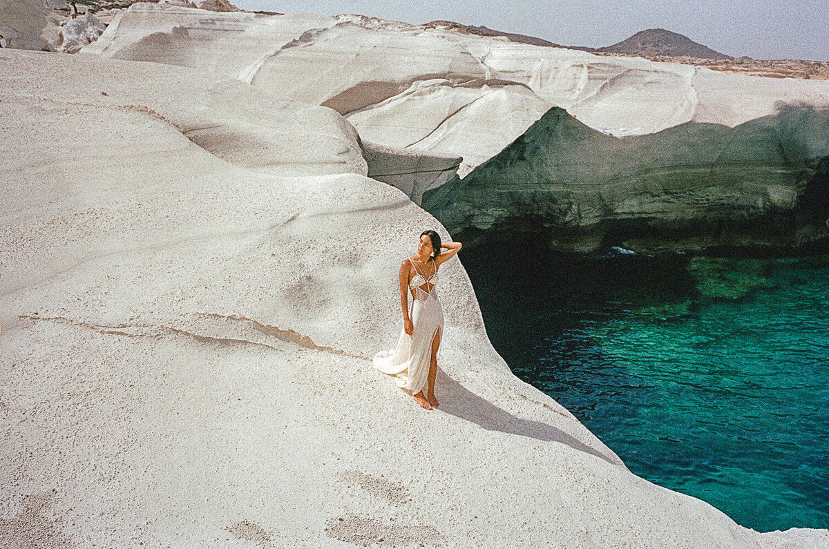 Bride standing at cliff and her elopement captured on film