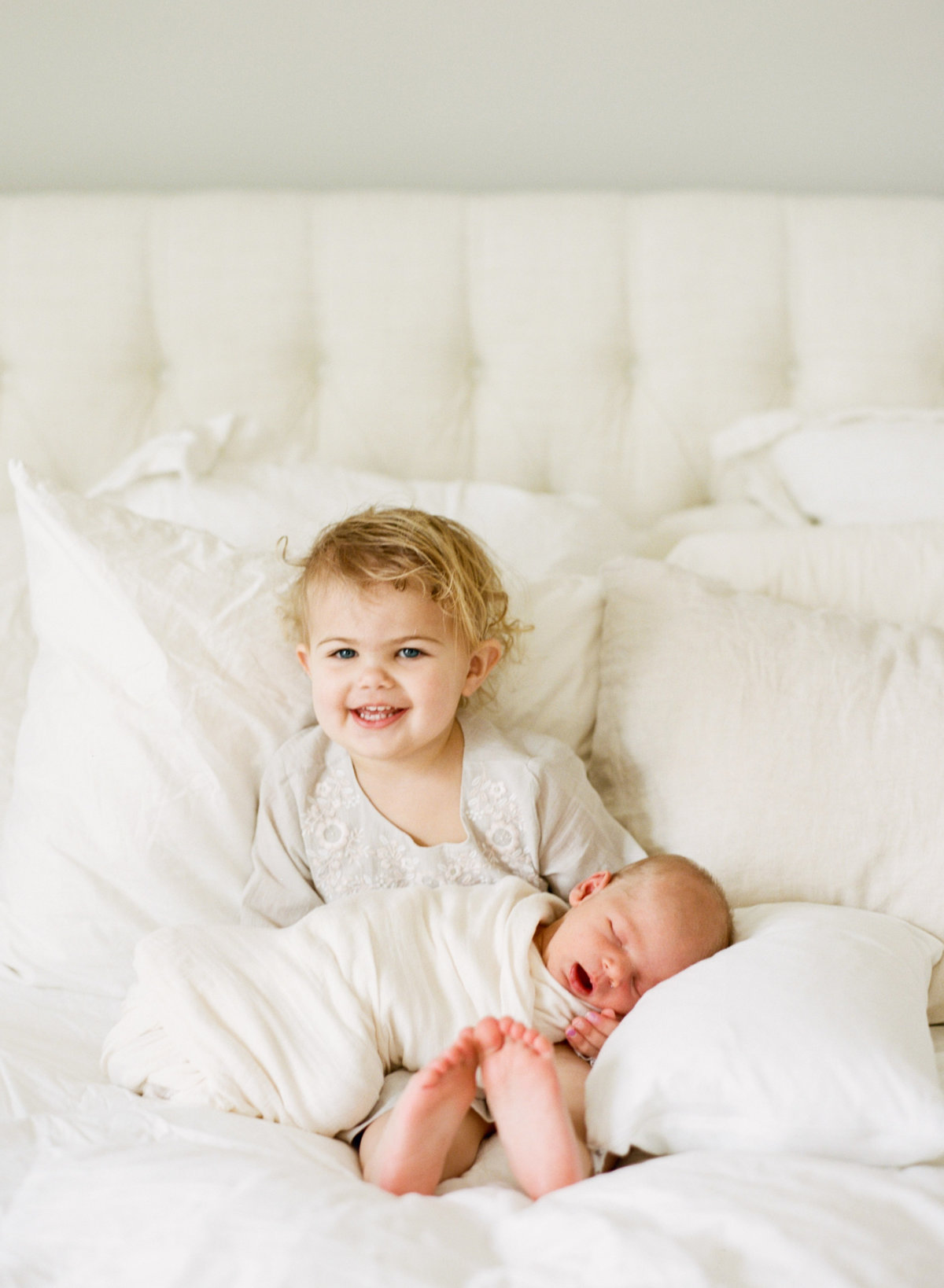 Big sister holds baby during a Cary NC newborn session. Photographed by Raleigh Newborn Photographer A.J. Dunlap Photography.