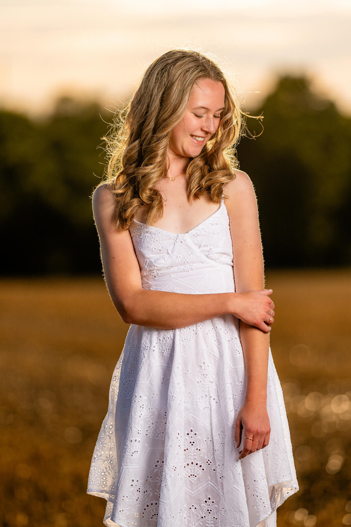 senior portrait photography of a graduate smiling and posing in a cornfield near Pittsburgh PA