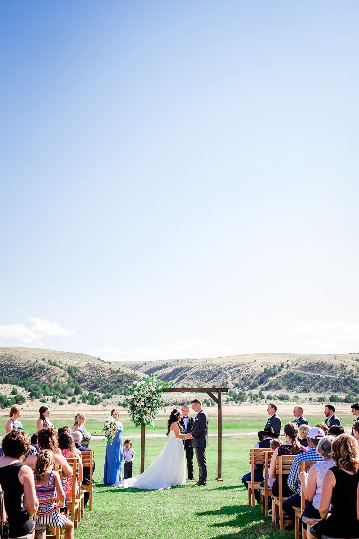 Couple holding hands during their ceremony at Headwaters Ranch