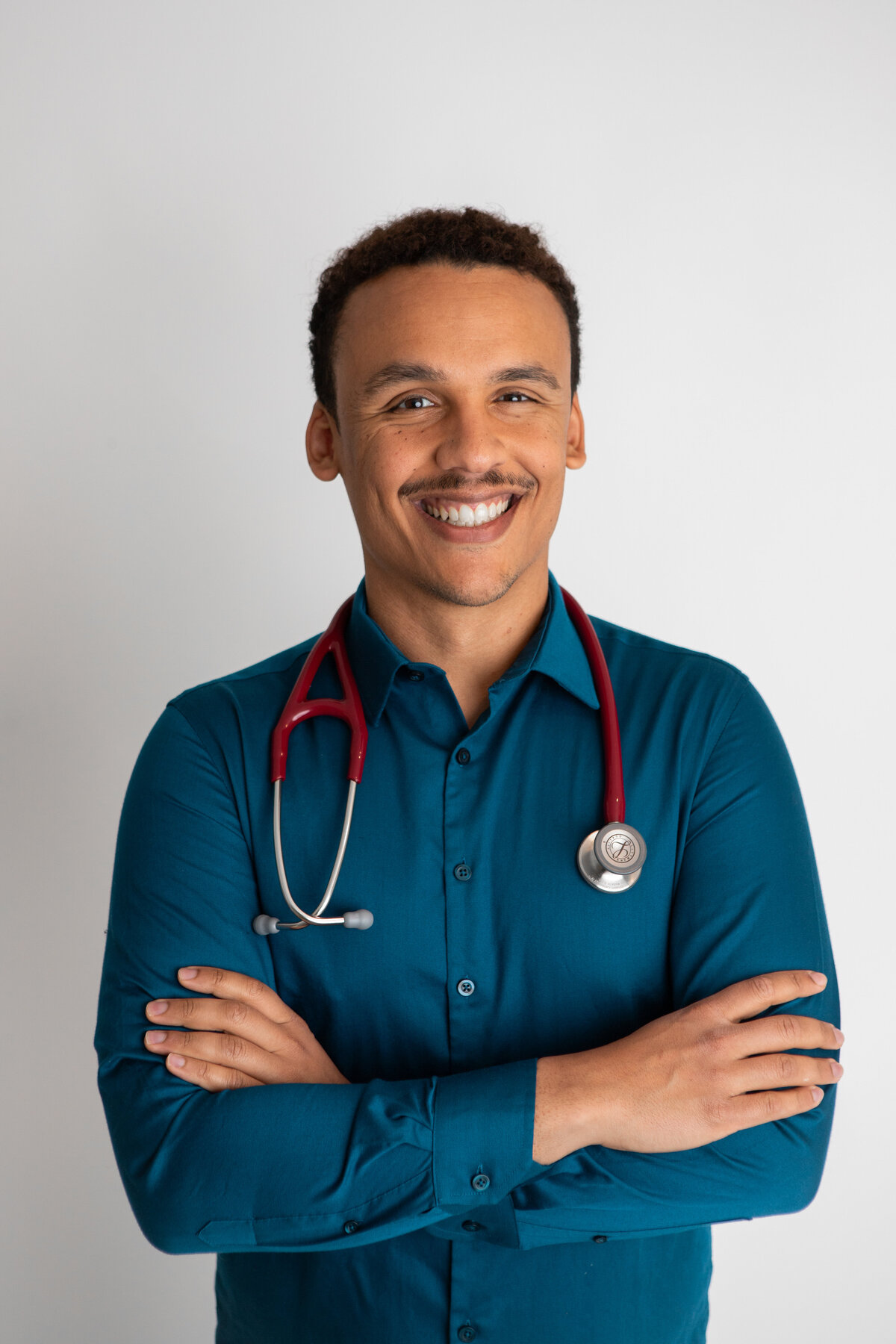 Teal shirt and red stethescope headshot