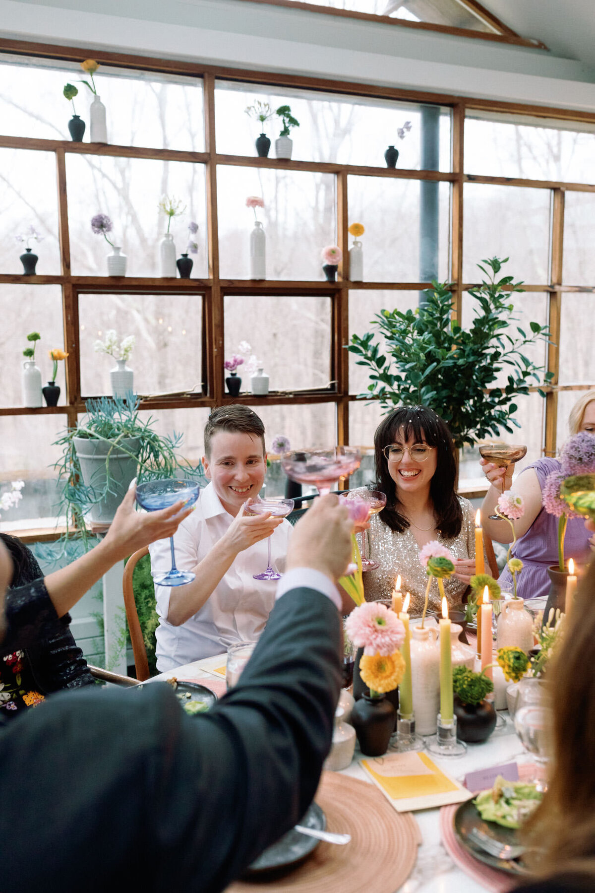 intimate wedding queer couple toasting with berkshire cider project champagne cider and flowers by little sister creative