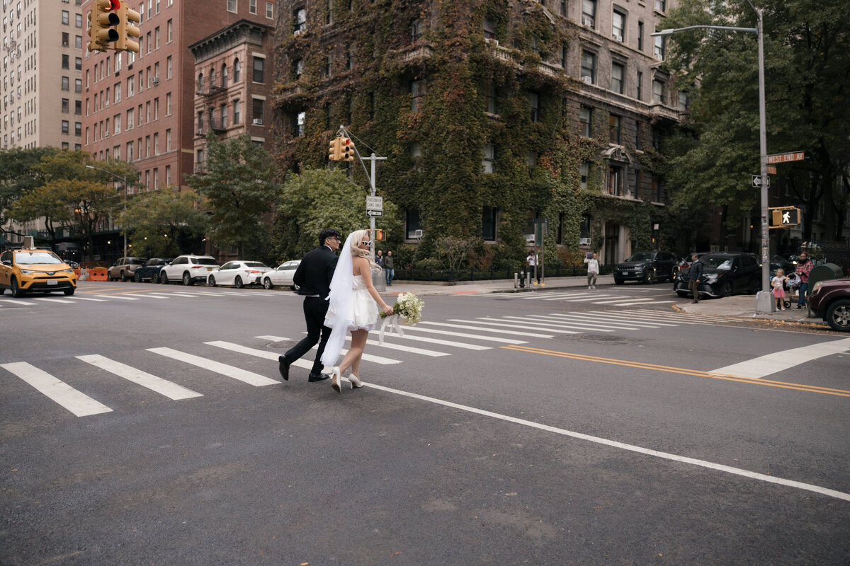 Couple walking hand-in-hand down a quiet NYC street during their elopement.
