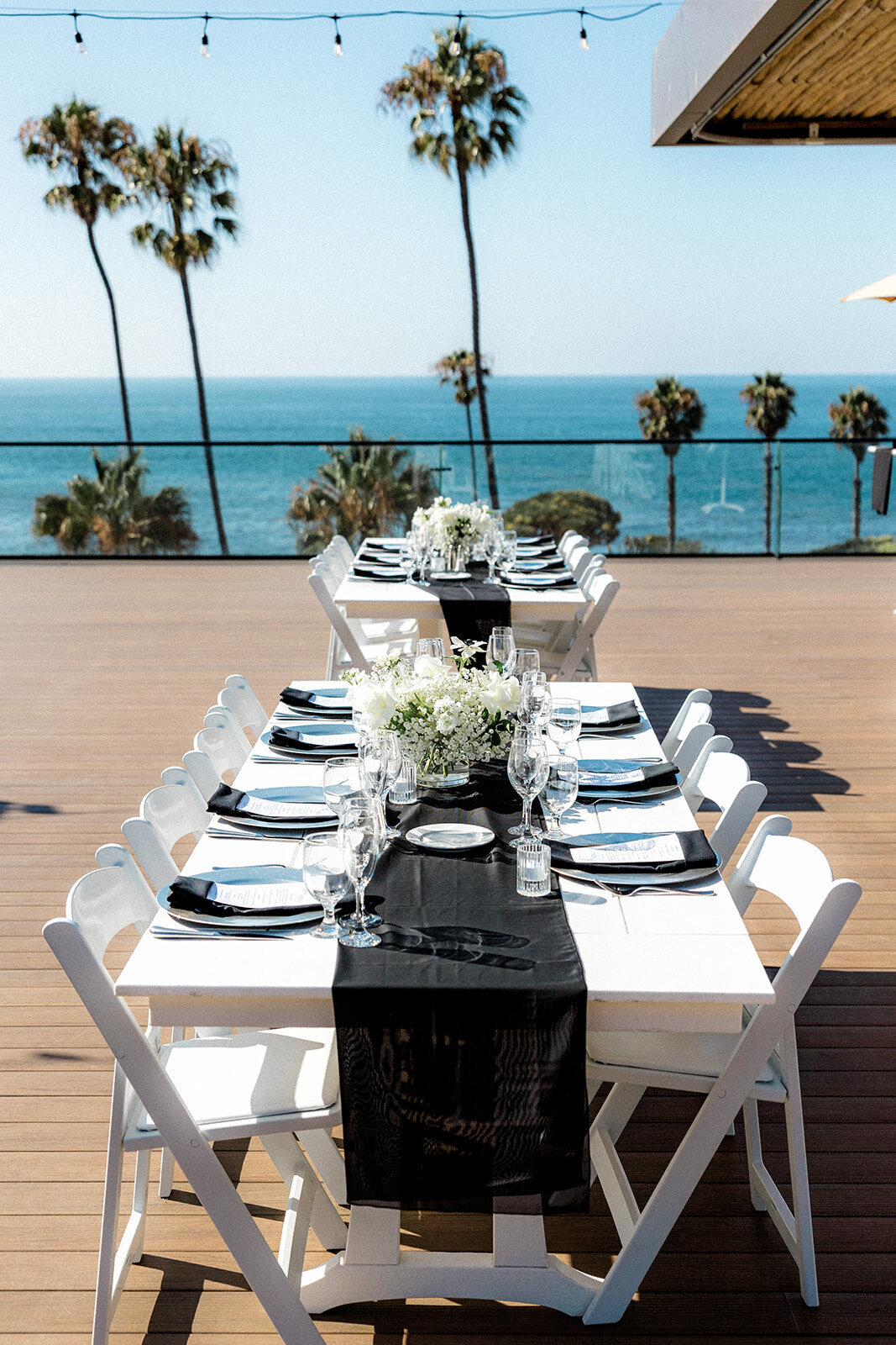 wedding table and centerpieces with palm trees in the background  at San Diego wedding