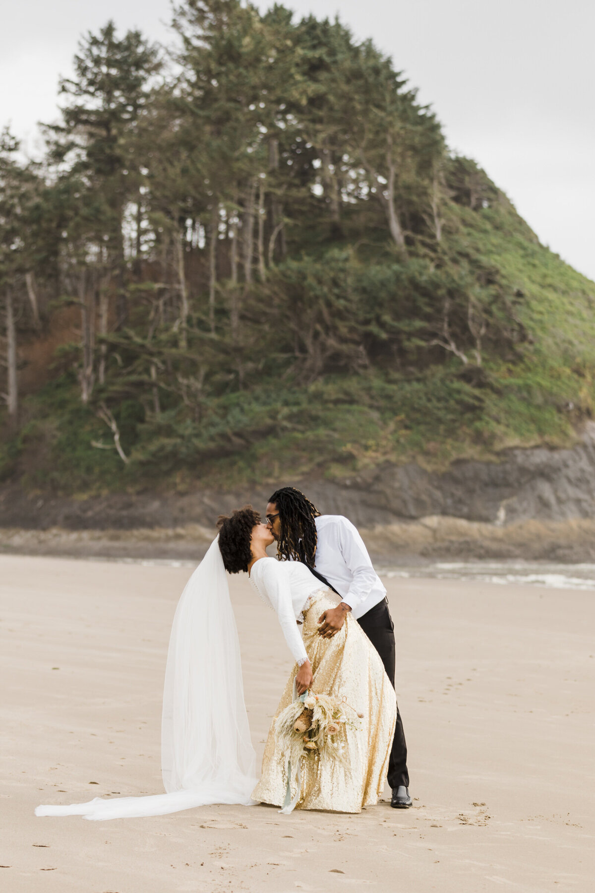 A BIPOC elopement on the Oregon Coast by Proposal Rock in Neskowin.