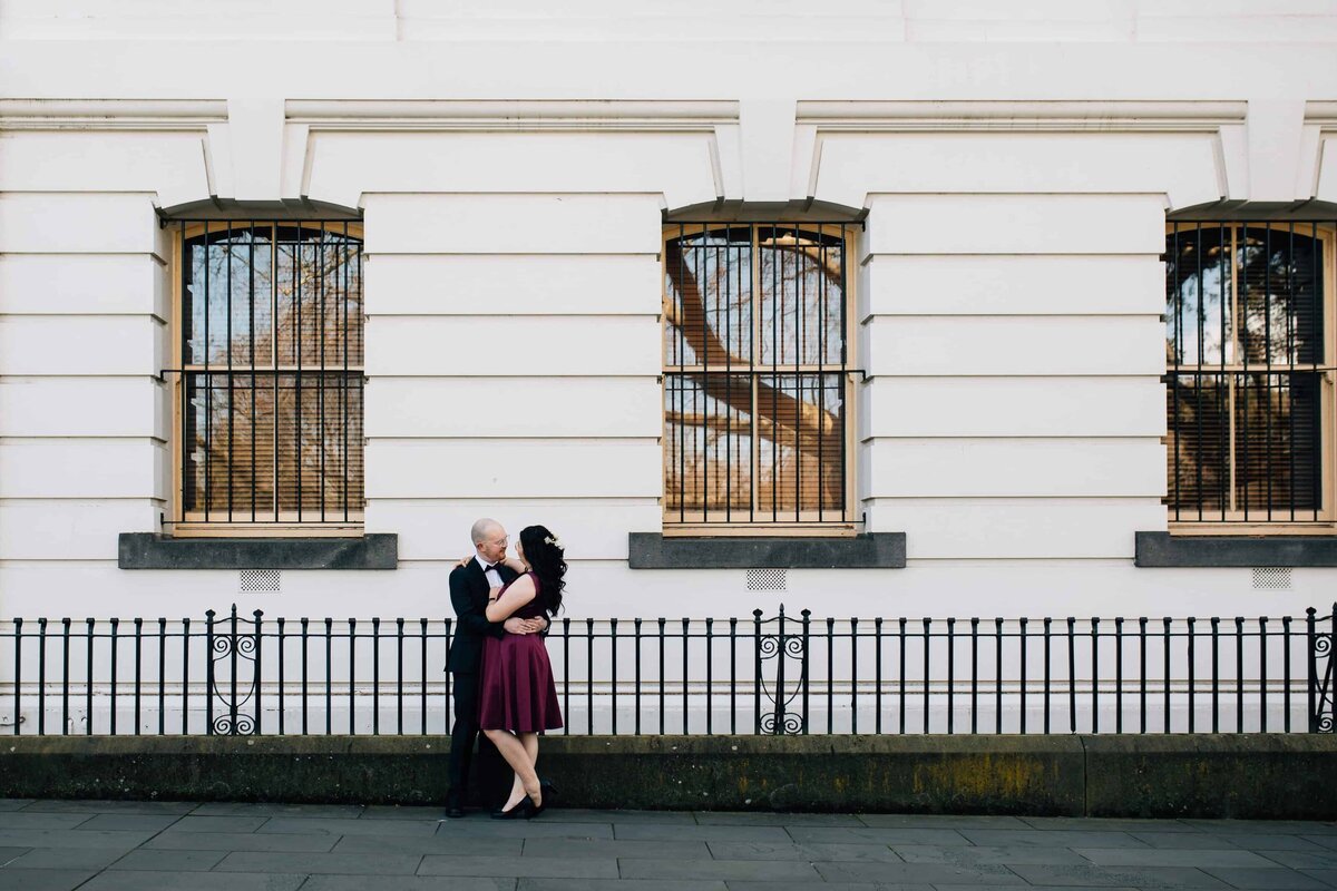 Wedding couple embracing in front of heritage building, Treasury Place Melbourne. Wedding couple photoshoot, And So I Don't Forget Photography