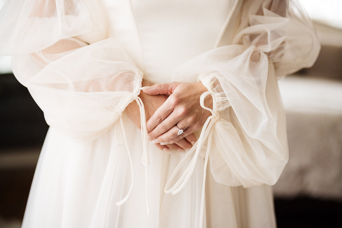 Sheet and tied sleeves of a wedding dress.