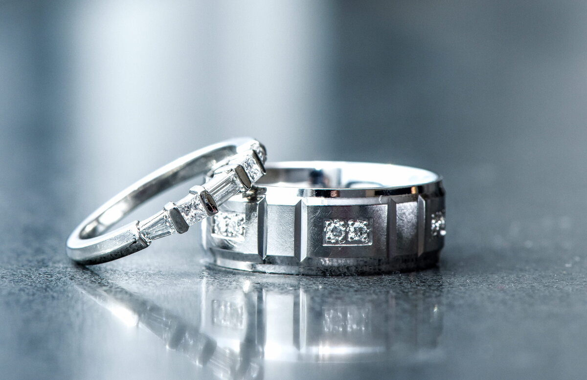 Close-up of wedding rings with diamonds, reflection.