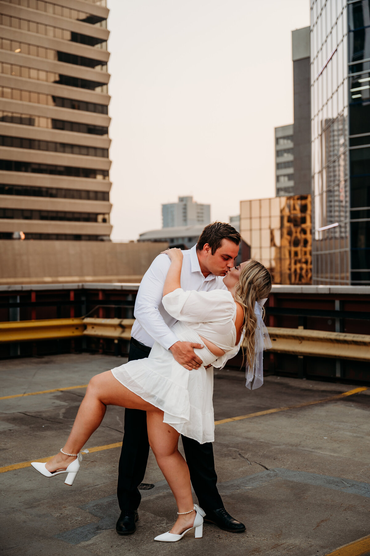 man dips his fiance and kisses her