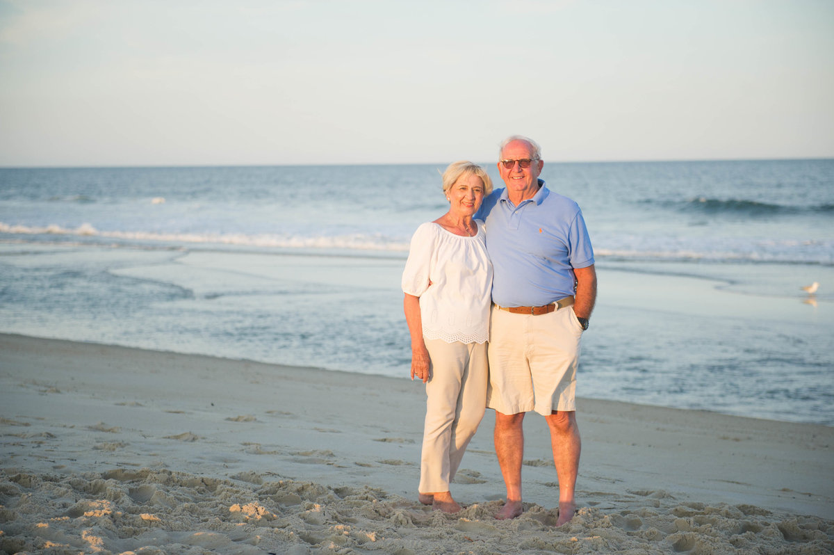 grandparents on beach at sunset