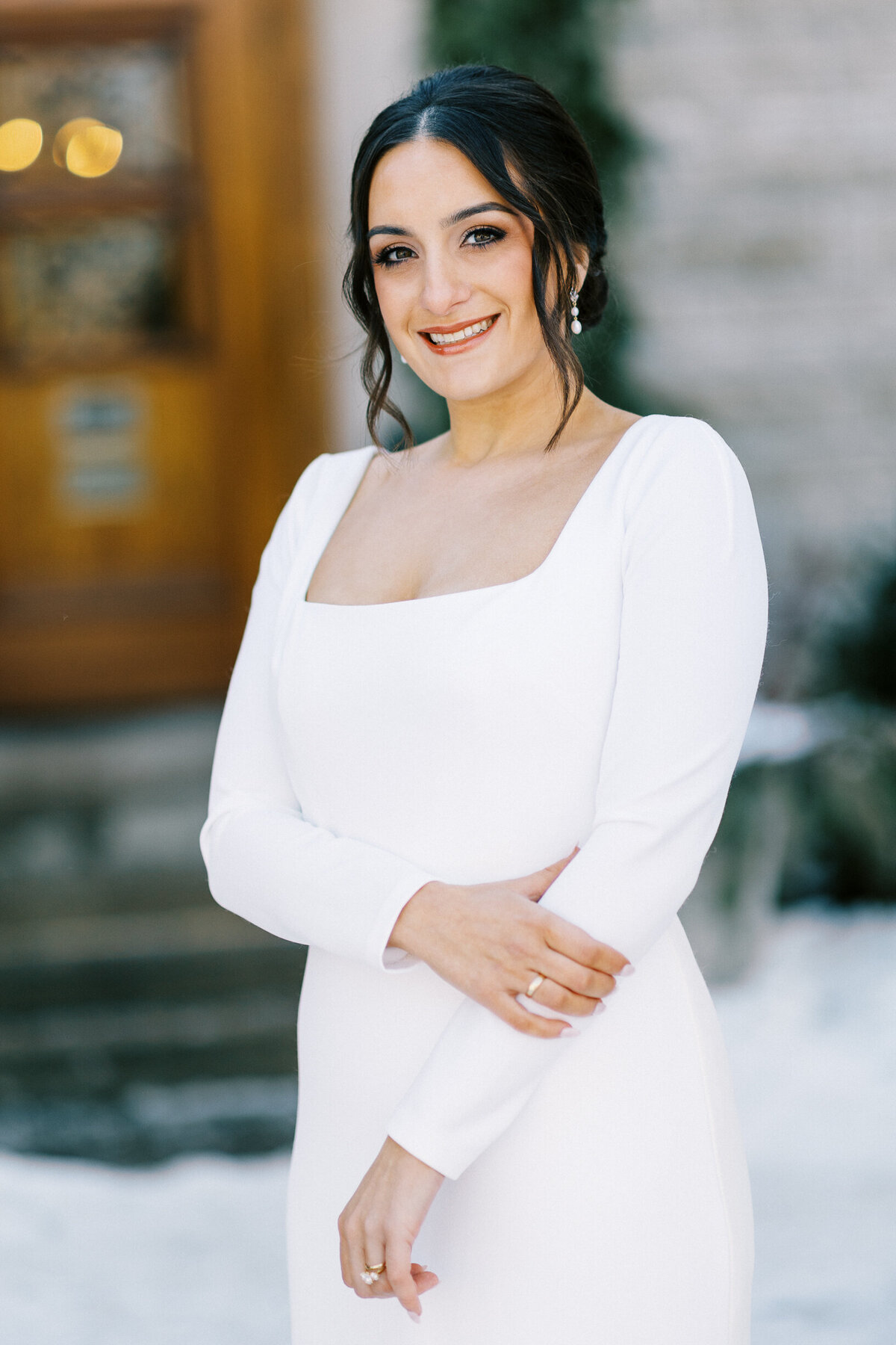 Bride posing for a photo in a white dress at St Paul College Club