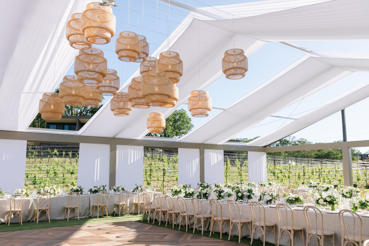 Tented wedding reception with greenery