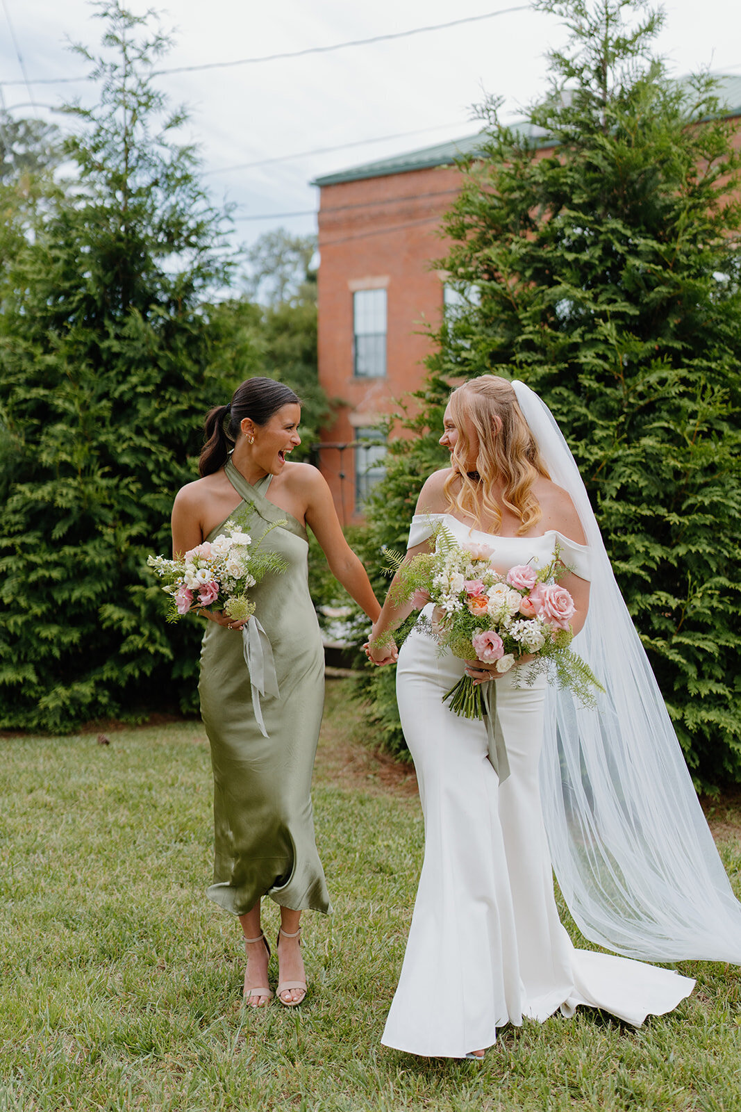 Bride and bridesmaid with bouquets designed by Abby Grace Florals at Easley SC wedding