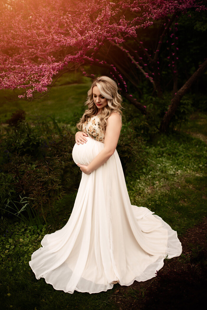 Grand Rapids Maternity Photography Mom looking at belly in White maternity gown by For The Love Of Photography.jpg