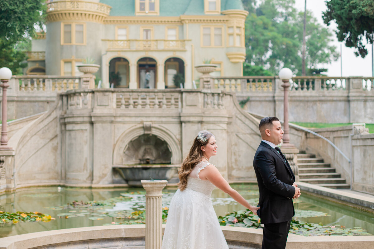 bride grabs grooms bottom during the first look