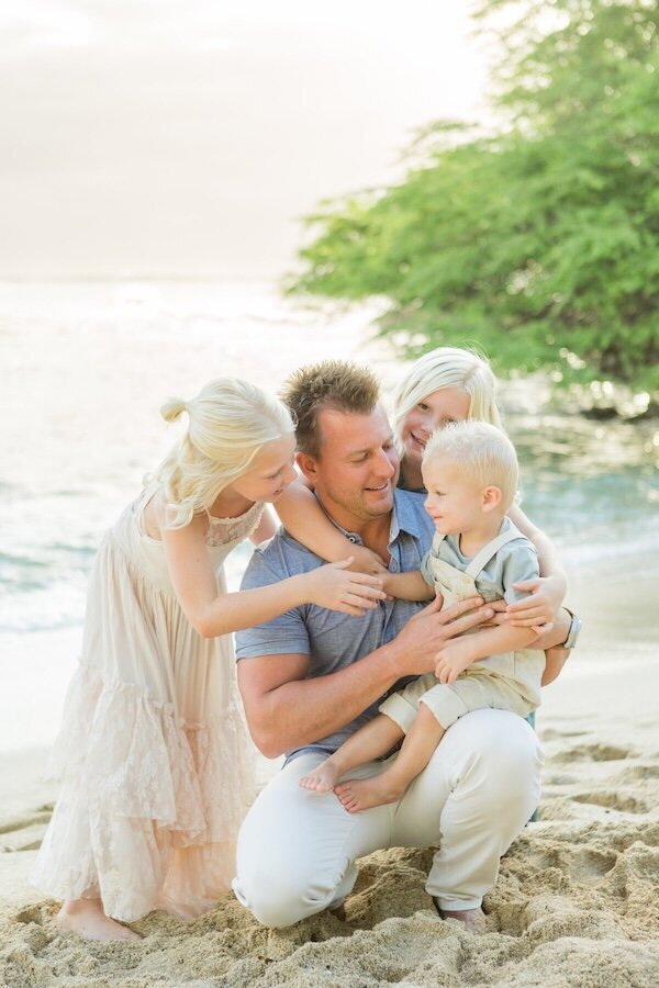 Oahu family photographer image of father and children on the beach. So cute. 