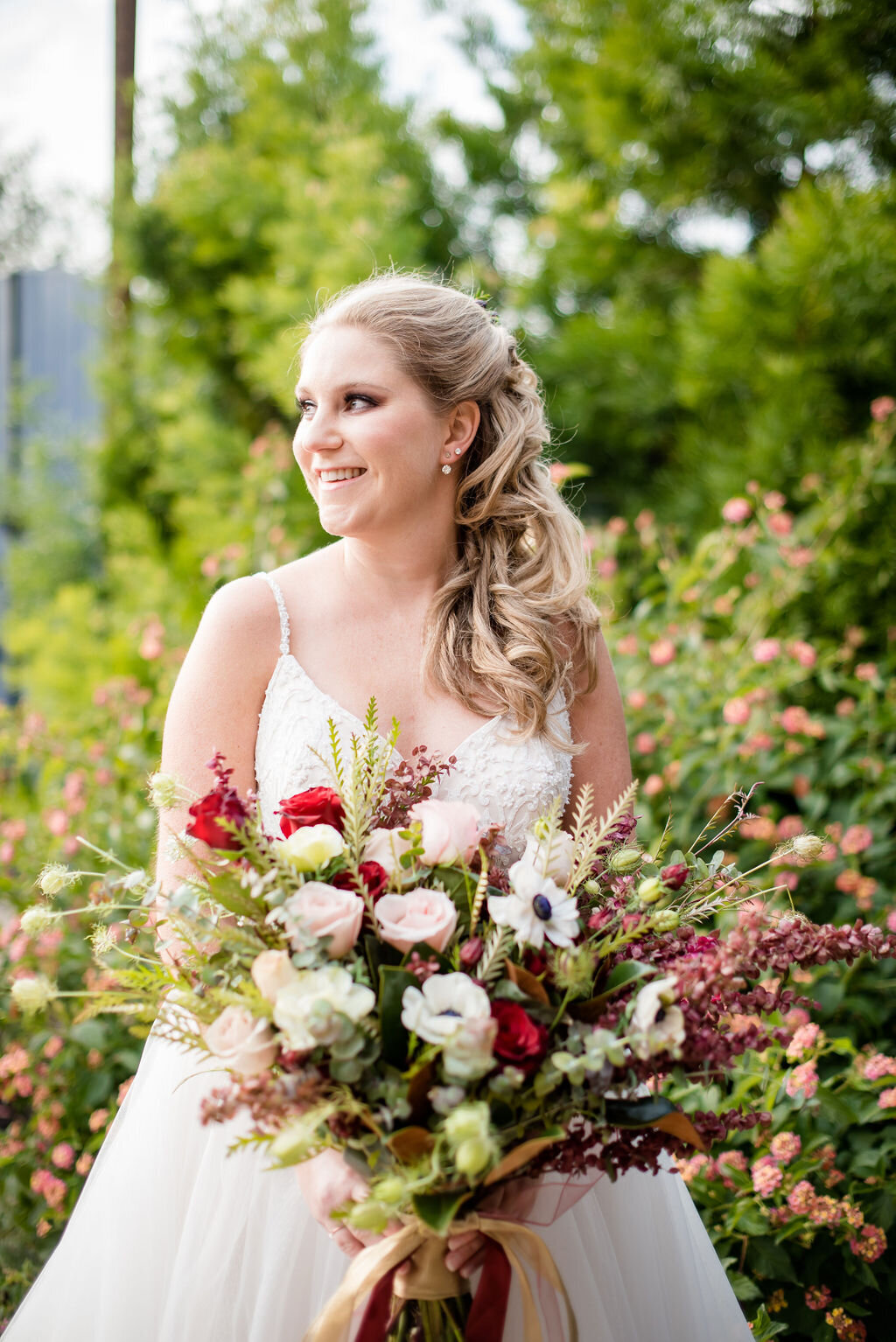 Blond hair blue eyed bride with purple smokey eye makeup and a soft pink blush and lip