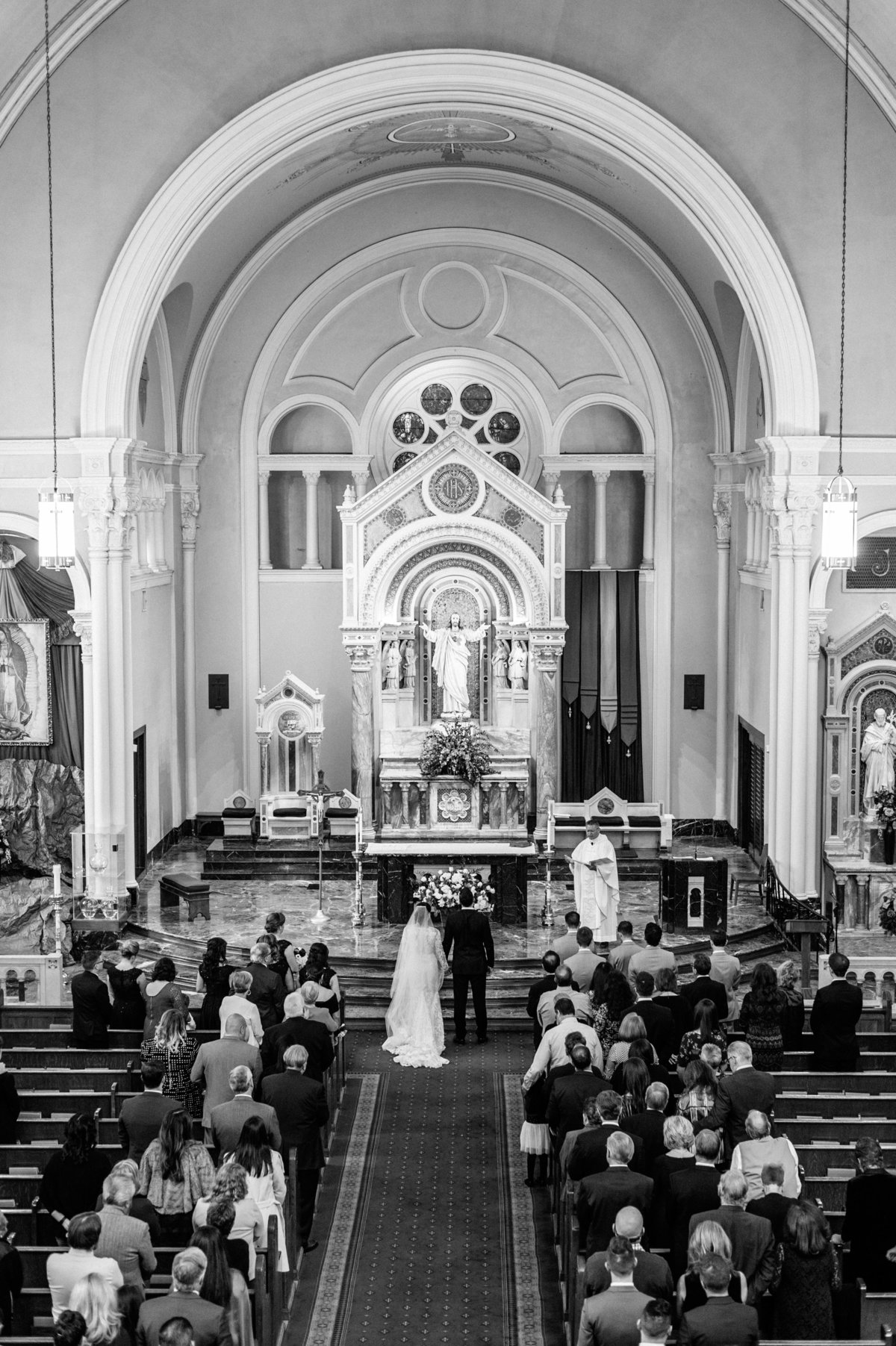 bride and groom at end of aisle in large cathedral