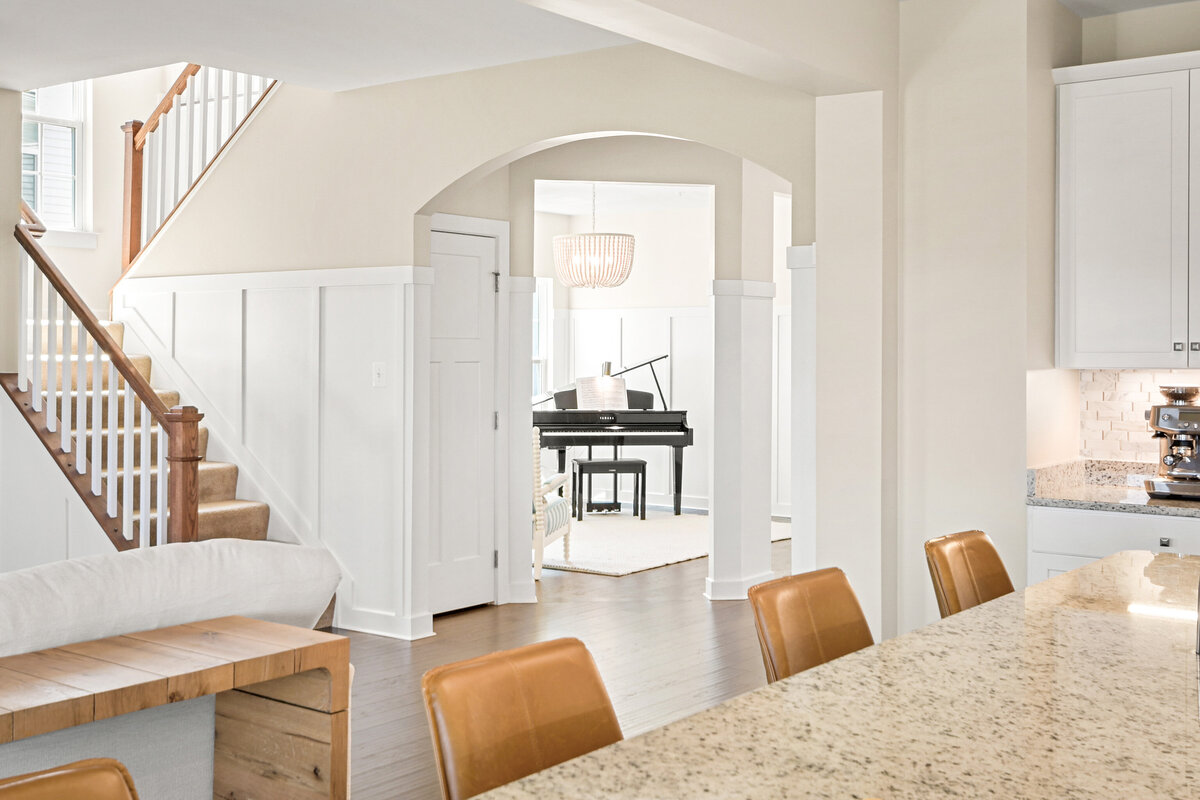 Zoomed out piano room and staircase