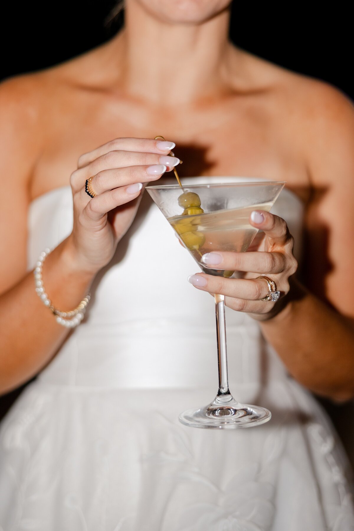 bride holding martini during reception at Westchester Country Club