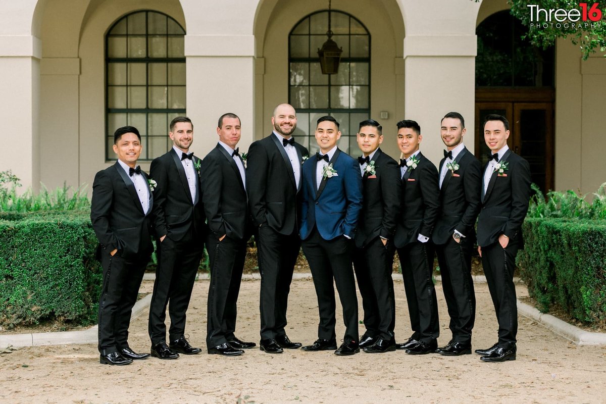The Groom and his Groomsmen posing for photos together