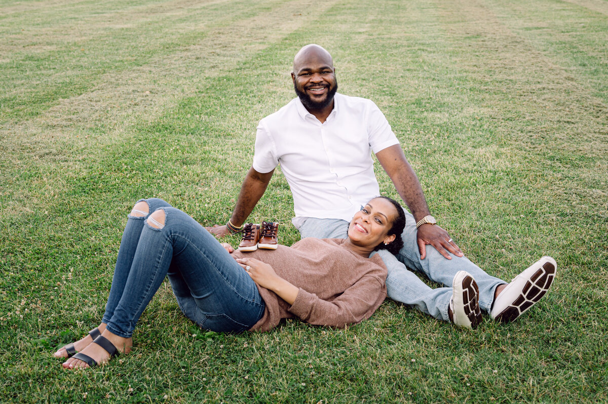 maternity session in the park with baby shoes on baby bump by jane osler 