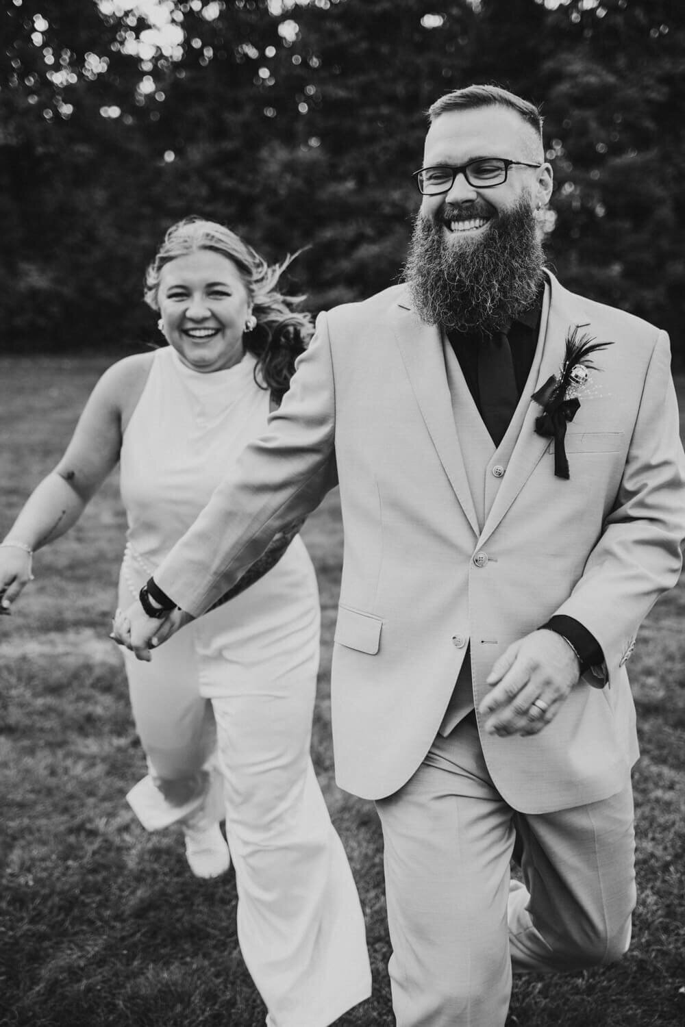 Couple runs towards dark and moody photographer